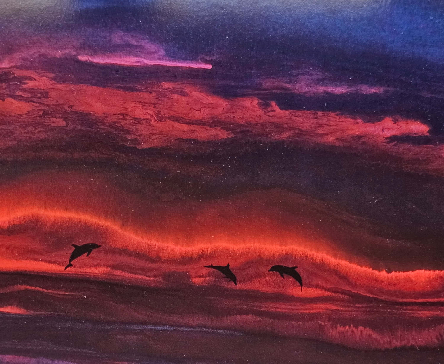 dolphins jumping during sunset Wyland artwork